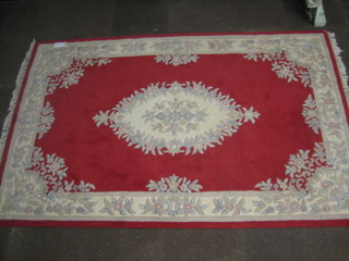 A white and red ground floral patterned Indian rug 100" x 64"