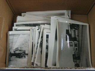 A cardboard box containing a large collection of various re-print black and white photographs of Buses and Trams
