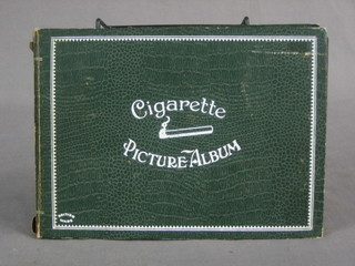 A green album of various black and white cigarette cards