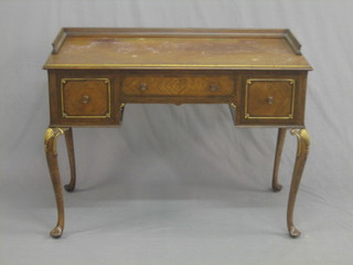 A 1930's Queen Anne style walnut dressing table with three-quarter gallery fitted 1 long drawer flanked by 2 short drawers, raised on cabriole supports 42"