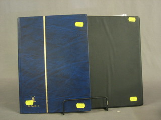 A black plastic ring bind album containing various GB stamps and a blue stock book of various World stamps
