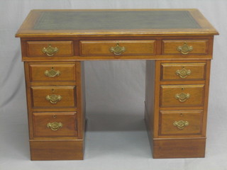 A Victorian mahogany kneehole pedestal desk with inset tooled leather writing surface above 1 long and 8 short drawers 42"
