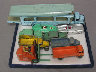 A  Dinky Pull More 580 car transporter, a Dinky Mercedes Benz 237 racing car, do. Connaught, a do. Hillman Imp motorcar, a Riley, do. Liverpool truck, do. Austin open truck together with an open truck and a Coventry Climax fork lift