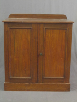 A Victorian mahogany cabinet with shelved interior enclosed by panelled doors 30"
