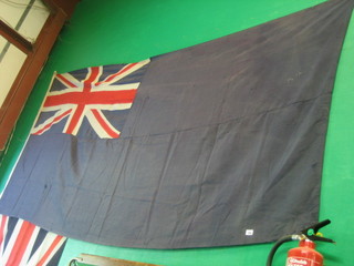 A large underfaced blue Ensign 52" x 102" (some moth holes)  together with a printed Union flag