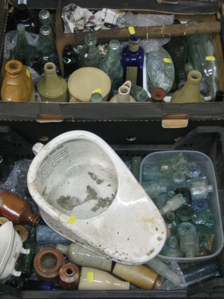 A collection of old bottles and a slipper bed pan