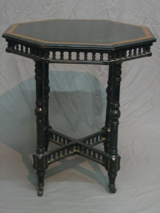 A Victorian ebonised occasional table the top with amboyna banding, raised on turned supports with X framed stretcher 22"