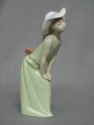 A Lladro figure of a standing girl in a green dress, base impressed F-2JT 9" (f)