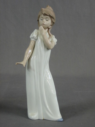 A Nao figure of a standing girl in a night gown 11"