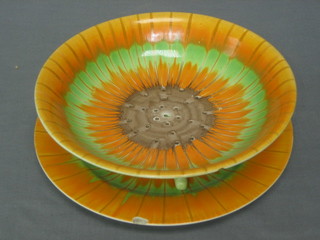 A Shelley Art Deco orange and green glazed circular straining dish with stand 8" (chip to stand)