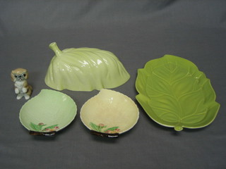 An oval Carltonware leaf shaped dish and cover 9", a Carltonware butter knife, 2 small Carltonware leaf shaped dishes 5" and a Wade figure of a dog 2"