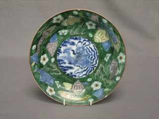 An Oriental circular plate with blue central panel decorated a figure surrounded by a green rim, the base with 2 character mark 8 1/2" (some chips to rim)