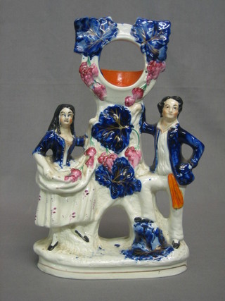 A 19th Century Staffordshire pocketwatch stand decorated a figure of a lady and gentleman 11" (f and r)