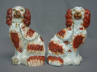 A pair of 19th Century Staffordshire figures of seated Spaniels (1 with crack to base) 10"