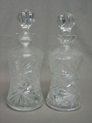 A pair of thistle shaped cut glass decanters and stoppers