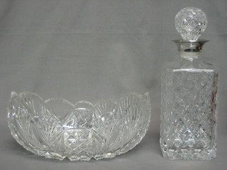 A cut glass square decanter with silver plated collar and a cut glass boat shaped dish 9"
