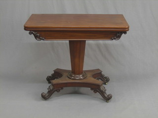 A William IV mahogany D shaped card table, raised on a chamfered column with triform base, raised on scrolled feet 36"