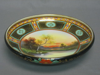 A circular Noritake porcelain bowl decorated a landscape 9 1/2"