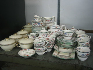 A 70 piece Copeland Spode Chinese Rose pattern tea service comprising teapot, large jug 6",  milk jugs (1 with crack to handle) 4",  1 jug 5", slop bowl 5", circular sucrier and cover, circular bowl 9", 2 square plates 9", a twin section dish 5", rectangular twin handled plate 13" (cracked), 9 lozenge shaped bowls 6 1/2", 12 tea plates 6" (6 cracked), 12 cups (2 chipped 1 cracked), 17 saucers (4 cracked, 5 chipped), 8 coffee cans (2 cracked), 5 saucers (1 cracked) together with 5 Wedgwood twin handled lidded soup bowls (4 cracked) and 6 saucers (4 cracked)
