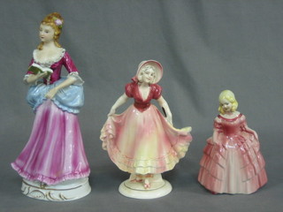 A German porcelain figure of a standing lady 8" and 2 other pottery figures of ladies