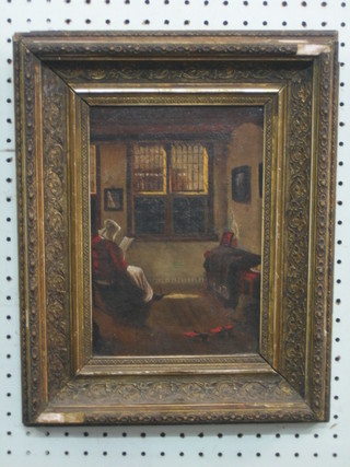 A 19th Century oil on canvas "Interior Scene with Seated Figure Reading a Book" 9 1/2" x 6 1/2"