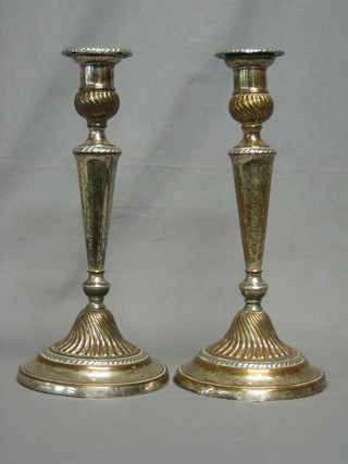 A good pair of 19th Century silver plated candlesticks with detachable sconces and gadrooned decoration 12"