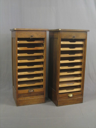 A pair of oak filing cabinets fitted drawers enclosed by tambour shutters 10"