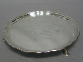 A silver salver with bracketed border, raised on 3 hoof feet, Birmingham 1932, 22 ozs, engraved