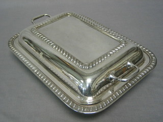 A rectangular twin handled silver plated entree dish and cover with gadrooned borders