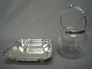 A cut glass biscuit barrel with silver plated mount and a square pierced silver plated cake basket with swing handle