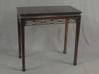 An Oriental rectangular side table with carved frieze raised on club supports 60"