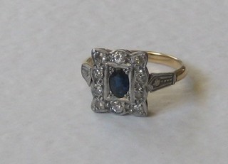 A 9ct gold dress ring set an oval blue cut stone supported by white stones