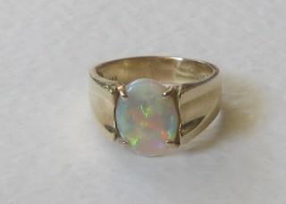 A 14ct yellow gold dress ring set an oval cut opal