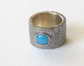 A designer dress ring set a cabouchon cut turquoise