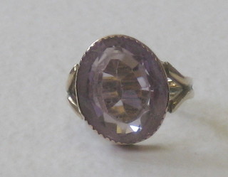 A gold dress ring set an oval cut amethyst