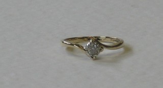 A 9ct gold dress ring set a single diamond