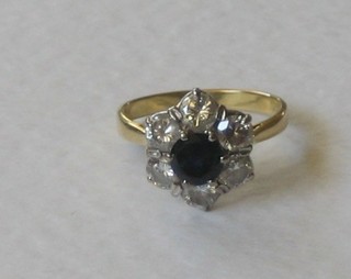 An 18ct gold dress ring set circular a  cut sapphire and 6 diamonds