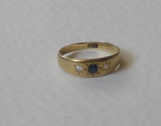 An 18ct gold dress ring set sapphires supported by 2 diamonds