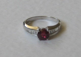 An 18ct white gold dress ring set an oval cut ruby and  baguette cut diamonds to the shoulders 950-1200
