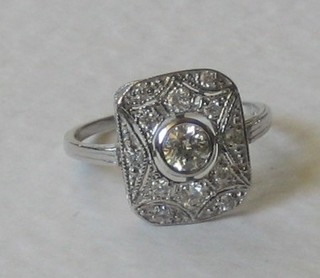 An 18ct white gold dress ring set circular diamond to the centre surrounded by numerous diamonds, approx 0.65ct