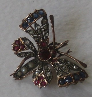 A handsome Edwardian brooch/pendant in the form of a butterfly with wings set diamonds, rubies, sapphires and pearls