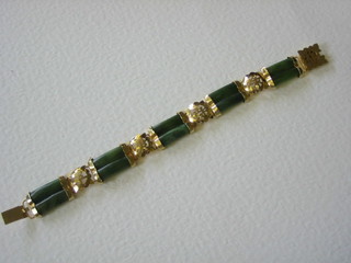 An Eastern gilt metal and jade coloured bracelet