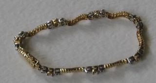 An 14ct yellow and white gold bracelet set tanzanite and diamonds