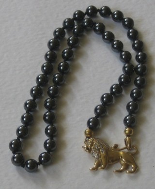 A string of Haematite beads with 18ct gold clasp in the form of a lion