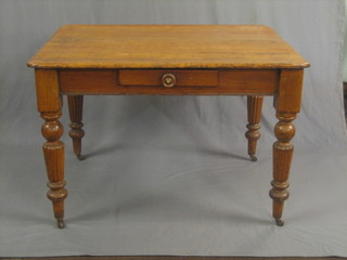 A Victorian rectangular pine kitchen table, fitted a frieze drawer and raised on reeded supports 45"
