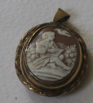 A Victorian pinch beck double sided pendant set a shell carved cameo of a seated scholarly child and a pierced ivory plaque of a stag