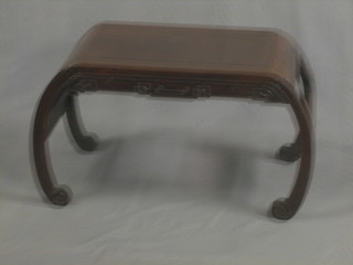 A Padouk coffee table, raised on curved supports 27"