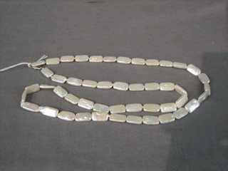 A rope of freshwater rectangular shaped cultured pearls with silver clasp 