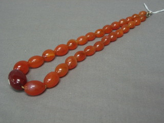 A string of pink hardstone beads