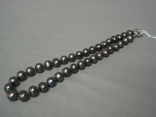 A rope of black fresh water pearls with silver clasp